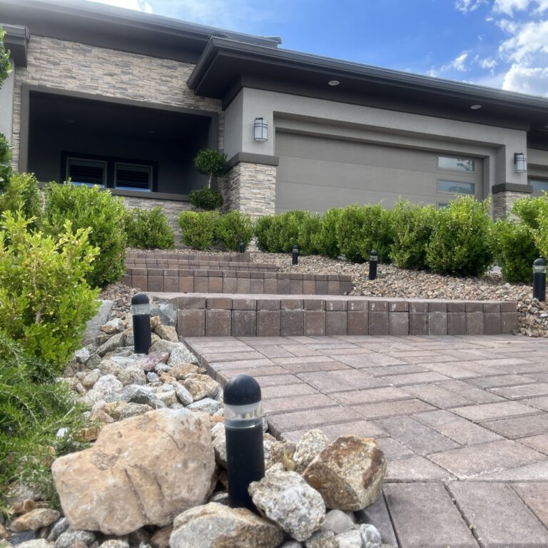 Landscape lighting ideas Las Vegas backyard with low voltage path and accent lights at dusk